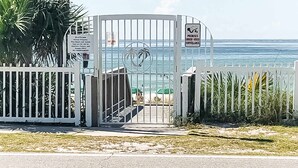 A gated entrance with a sign indicating private property and surveillance. - Family-friendly Gulf view condo with beach chair & umbrella, shared pool,hot tub (Miramar Beach)