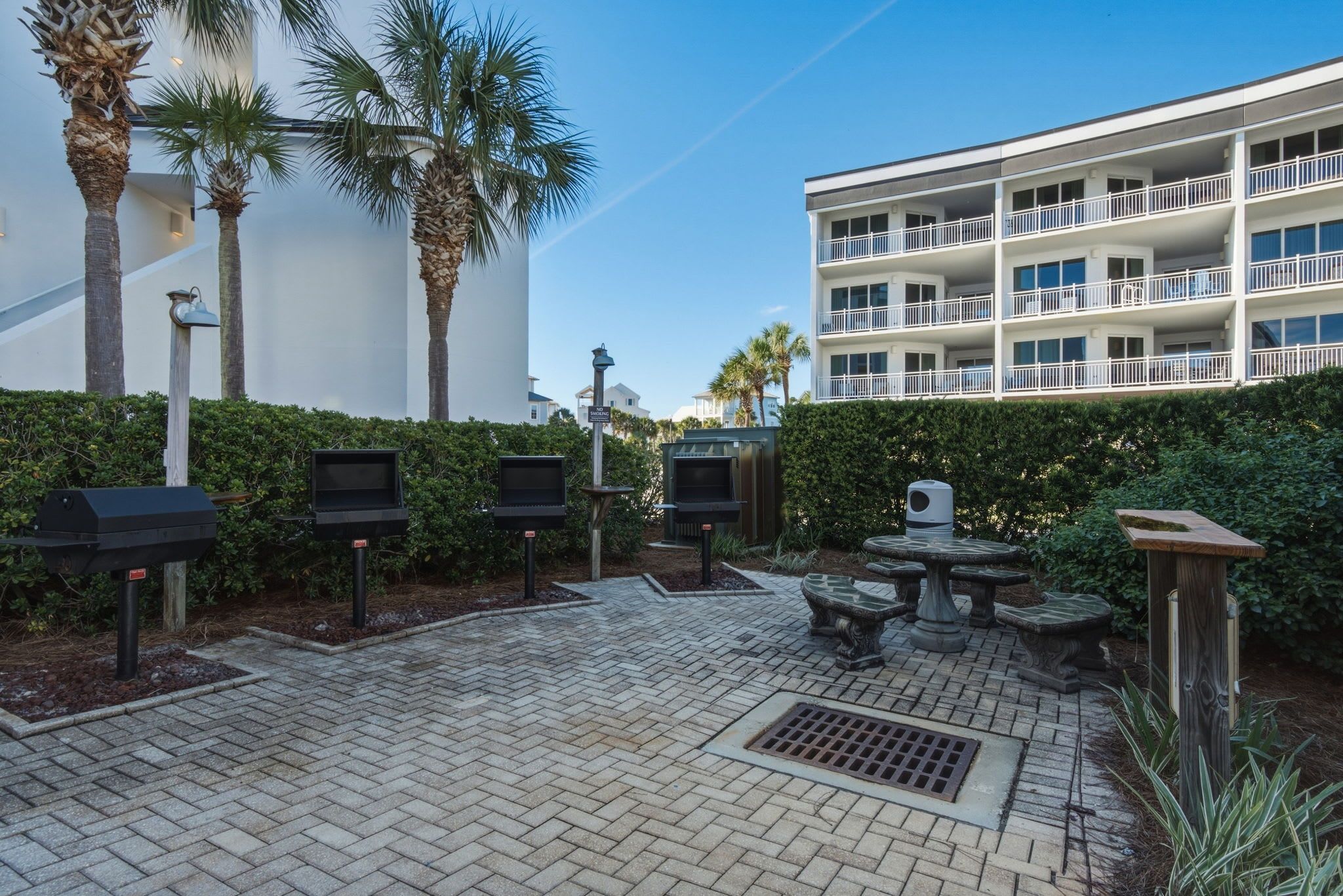 An outdoor patio area with grills, seating, and a pool table.