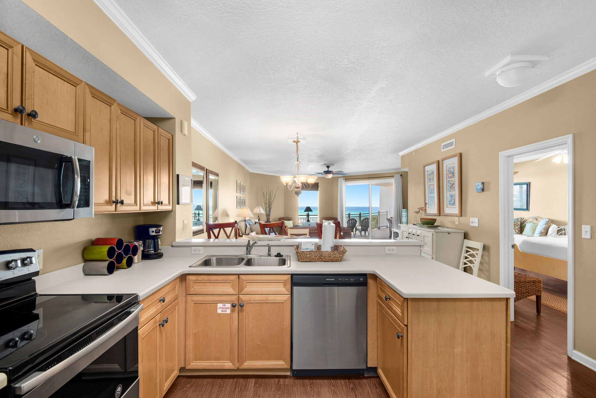 A modern kitchen with wooden cabinets, stainless steel appliances, and a central island.