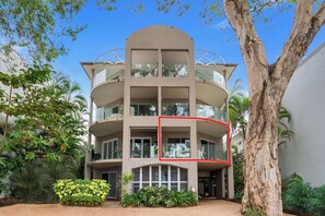 A multi-story building with balconies, surrounded by greenery. - Yasmin at Coral Horizons: Retro Vibes on the Beach (Palm Cove)