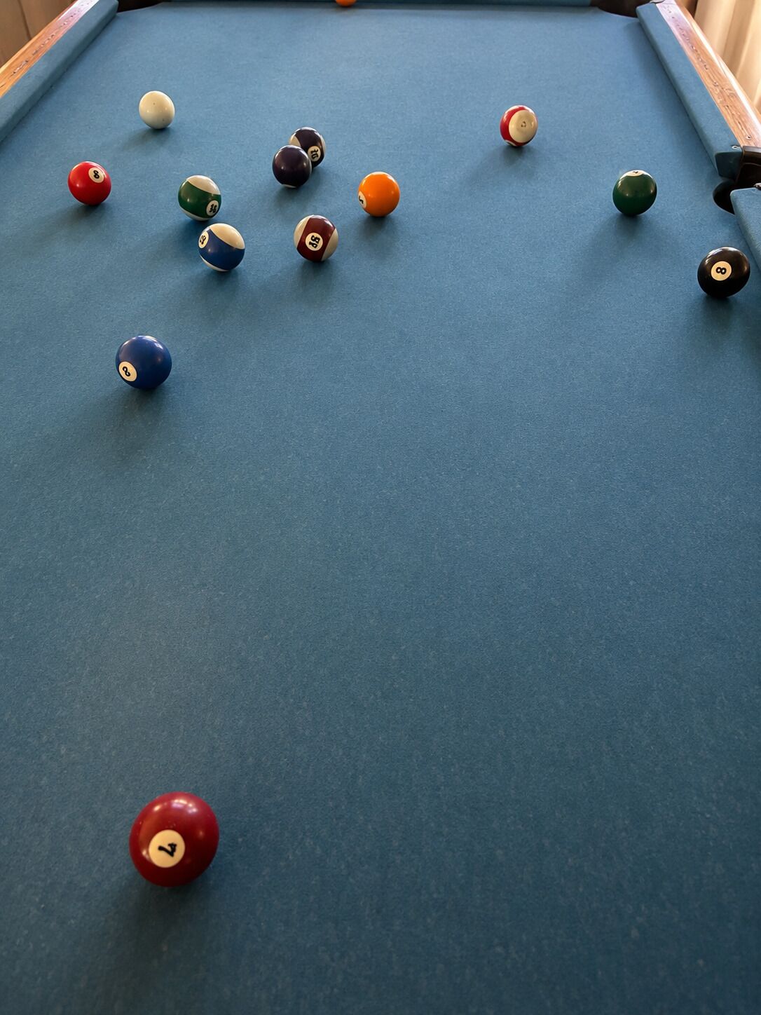 A pool table with various numbered balls.
