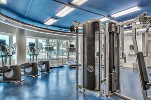 A gym with various exercise equipment, large windows, and a blue ceiling. - Condo At Waterscape, Incredible Gulf Views Playground, 2 Hot Tubs (Fort Walton Beach)