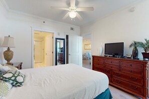 A bedroom with a bed, a dresser, a television, and a ceiling fan. - 2nd Floor Elegant, Spacious Condo At Waterscape Waterfall, Lazy River (Fort Walton Beach)