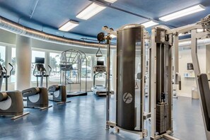 A gym with treadmills, elliptical machines, and weightlifting equipment. - 5th Floor Gulf-Front Condo w Free WiFi, Shared Hot Tub, Outdoor Pool, & More (Fort Walton Beach)