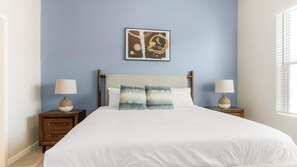 A bedroom with a bed, two bedside tables, two lamps, a headboard, and a wall art piece. - Landing | Stylish 1BD, Yoga Studio, Gym (Four Corners)