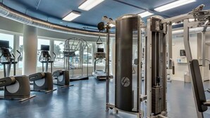 A gym with treadmills, weight machines, and a large exercise ball. - Inviting, Spacious Condo On Okaloosa Island Waterfall, Lazy River (Fort Walton Beach)