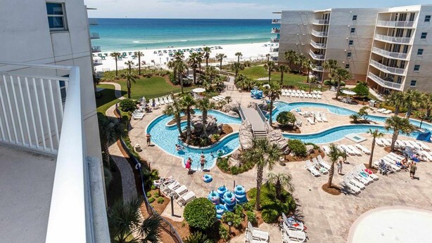 A resort with a pool area, beach, and ocean view. - Inviting, Spacious Condo On Okaloosa Island Waterfall, Lazy River (Fort Walton Beach)
