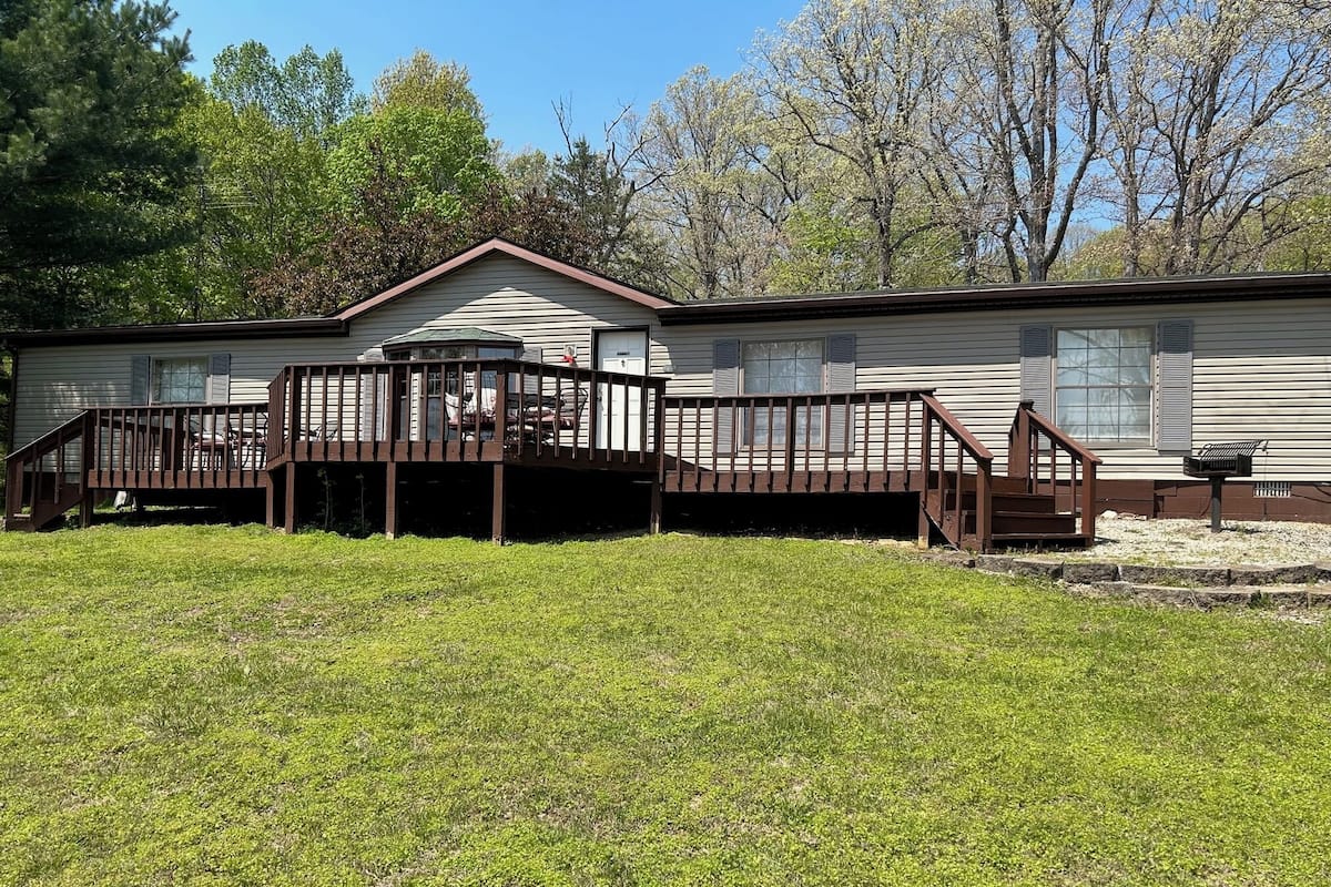 A single-story house with a porch and a small deck.