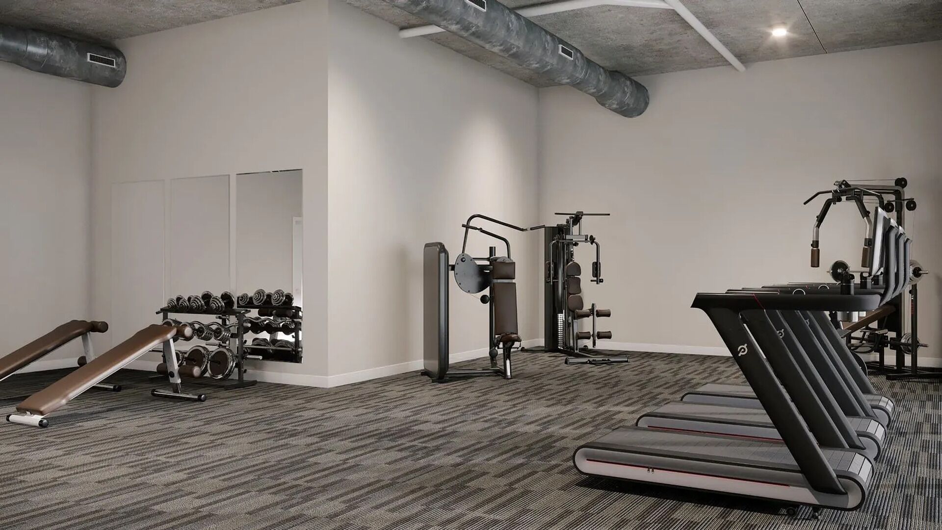 Une salle de sport moderne équipée de tapis de course, d’appareils de musculation et d’un banc.