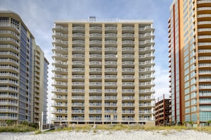A multi-story hotel with balconies, a beach view, and a sandy foreground. - Beautiful Gulf Shores Home w/Shared Pool, Hot Tub, and Sauna + Free WiFi (Gulf Shores)