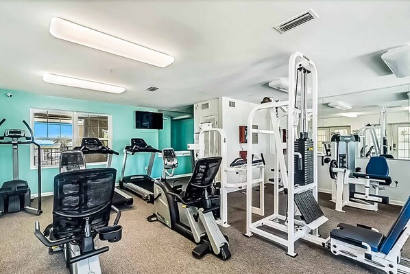 A gym with treadmills, elliptical machines, and weight equipment. - Snowbird-Friendly Condo w/Beach Access, Shared Outdoor Pool, Private Balcony (Orange Beach)