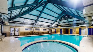 An indoor swimming pool with a high ceiling and a view of the sky. - Waterfront retreat with Gulf views, pools (Fort Morgan)