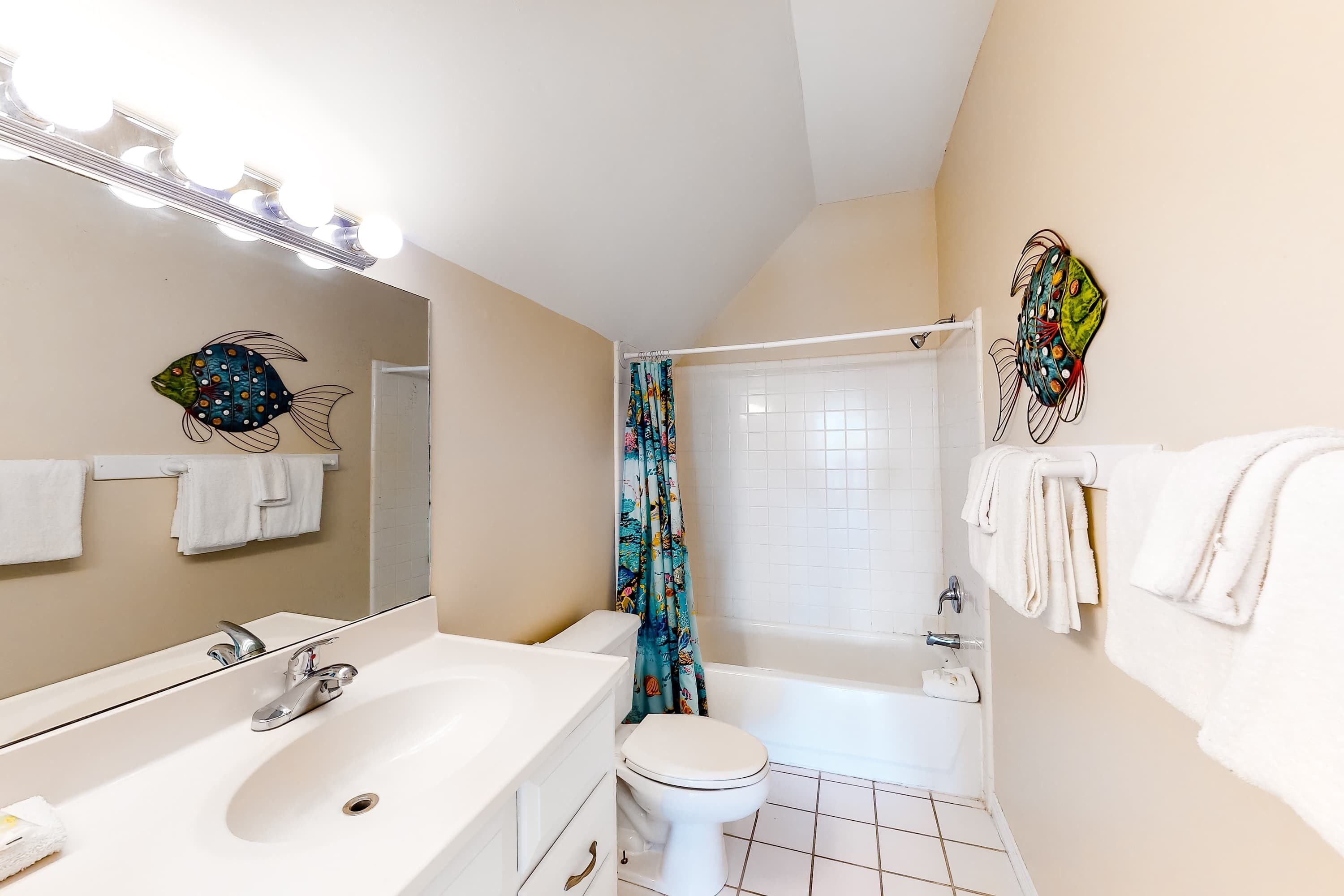 A bathroom with a sink, toilet, and bathtub.