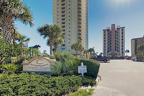 A high-rise building with a sign indicating 'Clearwater Condominium 517 East Beach Blvd.' - Clearwater condo with bunk room, pool, & balcony - walk to waves (Gulf Shores)