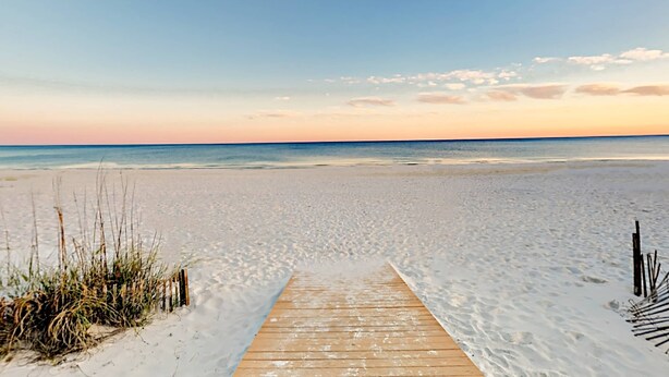 A wooden boardwalk leading to a beach with sand and sparse vegetation. - Centrally Located Oasis | Pool & Covered Balcony | Walk 1 Block to Beach (Gulf Shores)