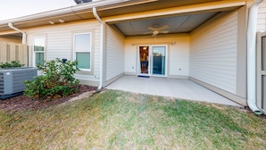 A residential house with a covered patio, a satellite dish, and a small garden. - Dog-Friendly Condo with Shared Pool, Central AC, & Free High-Speed WiFi (Gulf Shores)