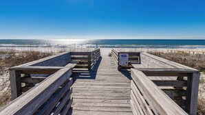 A wooden boardwalk leading to a beach with a clear sky. - Inviting Condo w/ Shared Pools, Hot Tub, Tennis, & Beach Access (Gulf Shores)