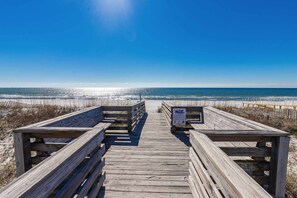 A wooden boardwalk leading to a beach with a clear sky. - Inviting Condo w/ Shared Pools, Hot Tub, Tennis, & Beach Access (Gulf Shores)