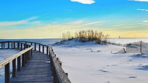 A wooden boardwalk leading to a sandy beach with a clear sky. - Two homes in one - beachfront, Gulf-view decks, central AC & washer dryers (Gulf Shores)