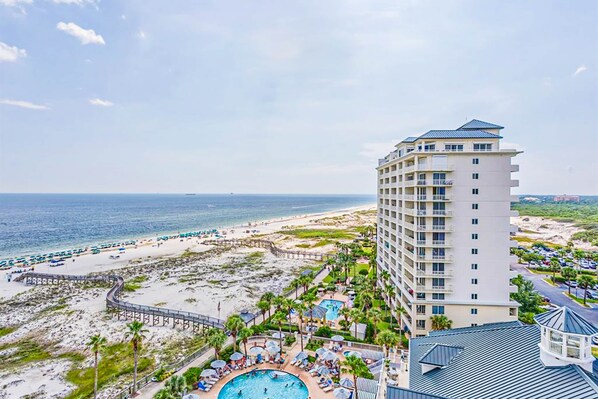 A hotel with a pool, beach, and ocean view. - Well-appointed condo with amazing views, pool, & hot tub - Close to beach (Fort Morgan)