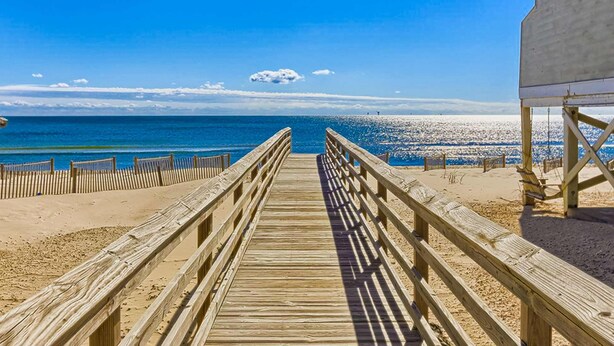 A wooden boardwalk leading to a beach with a clear view of the ocean. - Recently Remodeled Condo w/Private Deck, Shared Outdoor Pool, Central AC, WiFi (Fort Morgan)