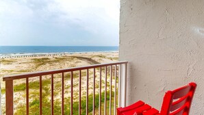 En balkong med utsikt över stranden och havet.