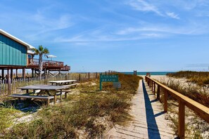 A wooden boardwalk leading to a beach area with a sign reading 'CABANA BEACH.' - Two-story home with WiFi, partial ocean views, covered deck, dock, and W&D (Fort Morgan)