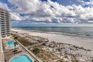 A hotel with a pool, beach access, and a view of the ocean. - Gulf-front condo with hot tub, sauna, indoor pool & beach access - near dining (Gulf Shores)