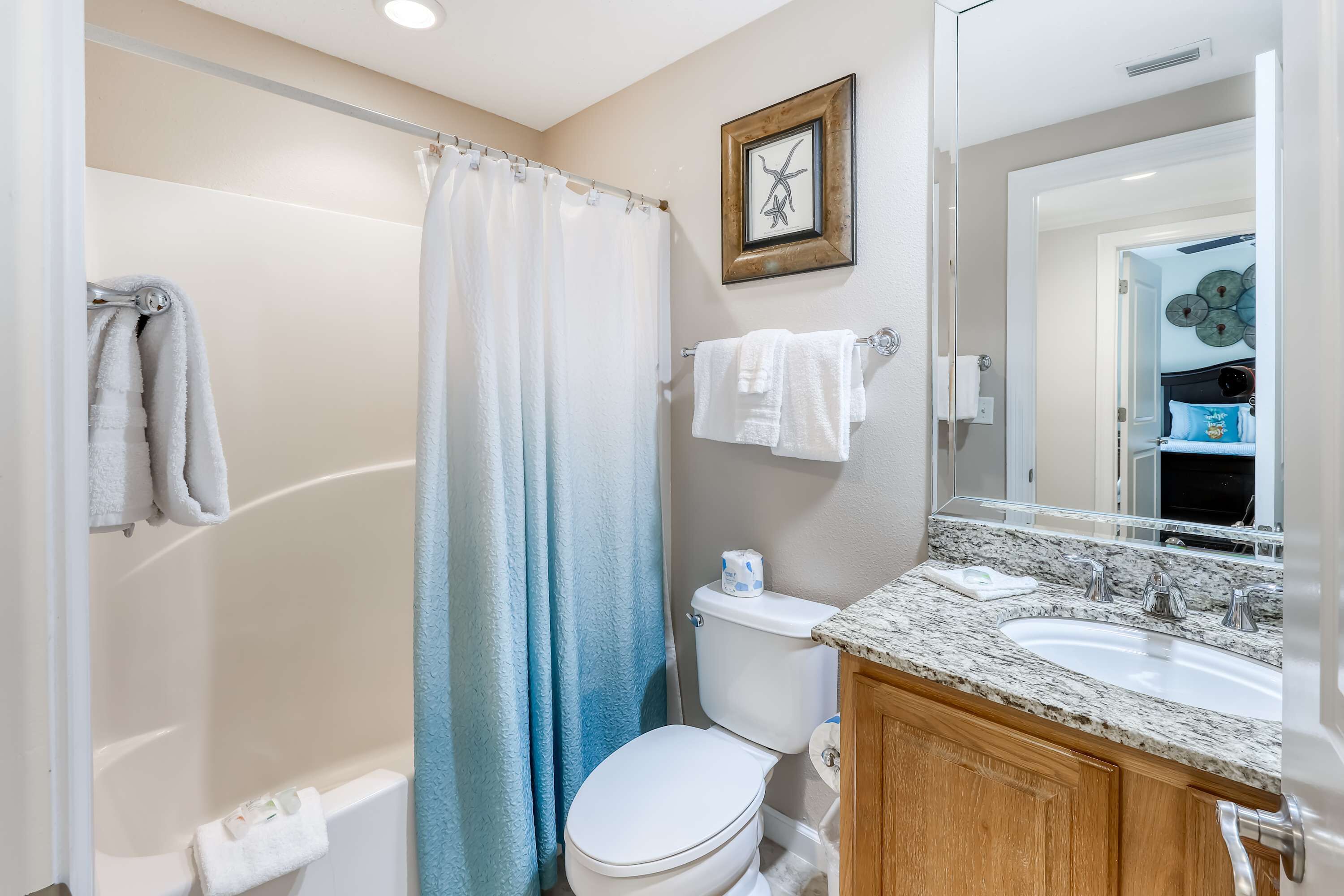 A bathroom with a shower, toilet, and sink.