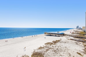 A beach with a pier, sandy beach, and a clear blue sky. - Gulf-Front 4th-Floor Condo w/Shared Outdoor Pool, Central AC, Private Balcony (Gulf Shores)