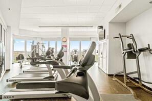 A gym with treadmills, elliptical machines, and weight equipment. - Gulf-Front Condo w Great Beach Views, Balcony & Shared Pools, Hot Tubs & Sauna (Gulf Shores)