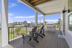 Outdoor dining - Inviting home with shared pool, balcony, full kitchen, central AC, & W&D (Gulf Shores)