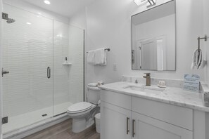 Shower, hair dryer, towels - Inviting home with shared pool, balcony, full kitchen, central AC, & W&D (Gulf Shores)