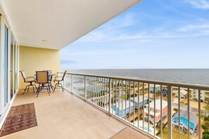 Outdoor dining - Gulf-view retreat with washer,dryer, AC, pool, sauna, & fitness center (Gulf Shores)