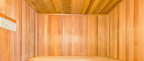 A sauna with wooden walls and benches.