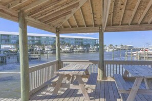 Outdoor dining - Waterfront condo with bay views, pool, hot tub, boat ramp, & private balcony (Gulf Shores)