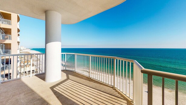 A balcony with a view of the ocean and a beach. - Gulf-Front, 12th-Floor Condo w Great View, Balcony, AC & Shared Pools Hot Tubs (Gulf Shores)