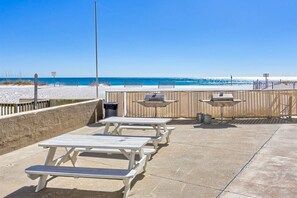 Outdoor dining - Beachfront condo with balcony, pool, BBQ area, central AC, free WiFi, views (Gulf Shores)