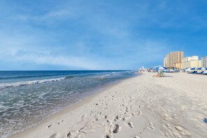 A beach with footprints, a clear sky, and buildings in the background. - Gulf-Front Retreat Perfect For Couples w/Shared Pool & Hot Tub, Free WiFi, & W/D (Gulf Shores)