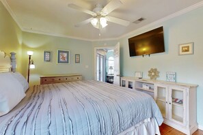 A bedroom with a bed, a ceiling fan, a TV, and a cabinet. - Wonderful Family Retreat Near the Coast with Free WiFi & Shared Pool Hot Tub (Gulf Shores)