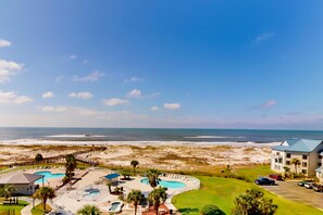A resort with multiple swimming pools, a beach view, and a parking area. - Newly updated beachfront condo with Gulf view, indoor,outdoor pools & hot tub (Gulf Shores)