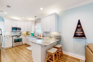 Fridge, microwave, oven, stovetop - Modern beach home with screened porch, on-site pool, AC, & W&D (Gulf Shores)