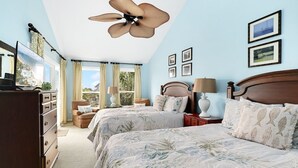 A bedroom with two beds, a ceiling fan, a dresser, and a window with curtains. - Seabrook Exclusives | 2942 Atrium (Seabrook Island)