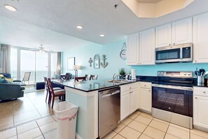 A modern kitchen with white cabinets, a built-in microwave, and a dishwasher. - Gulf-Front Condo w Big Beach Views, Balcony, WiFi & Shared Pools, Hot Tubs & Gym (Gulf Shores)