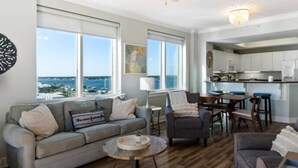 A living room with a sofa, armchairs, a coffee table, and a view of the ocean. - Gorgeous Gulf view condo with indoor,outdoor pools, hot tubs, gym, & balconies (Gulf Shores)