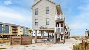 A multi-story building with a balcony and a sign reading 'SPYGLASS.' - Beachfront condo with outdoor pool, beach views, washer/dryer, beach access (Gulf Shores)