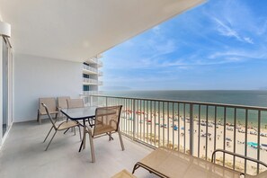 Outdoor dining - Oceanfront condo with sweeping views, washer/dryer, central AC, & access to pool (Gulf Shores)