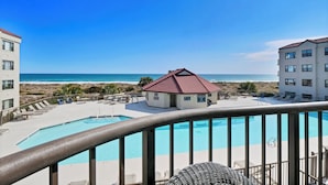 A pool area with a lifeguard station, lounge chairs, and a view of the beach and ocean. - 3BR/3BA Dune Ridge Condo with Elevator, Pool & Ocean Views (Wrightsville Beach)
