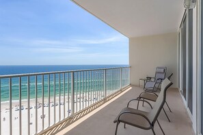 A balcony with a view of the beach and ocean. - Gulf-Front Condo w Beach Access, WiFi, Balcony & Shared Pools, Hot Tubs & Gym (Gulf Shores)