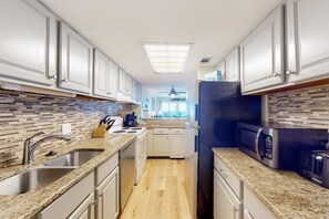Fridge, microwave, oven, stovetop - Inviting condo with ocean view, on-site pool, cozy balcony, washer/dryer & AC (Gulf Shores)